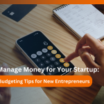 A business owner reviewing financial documents and using a calculator to manage startup finances.